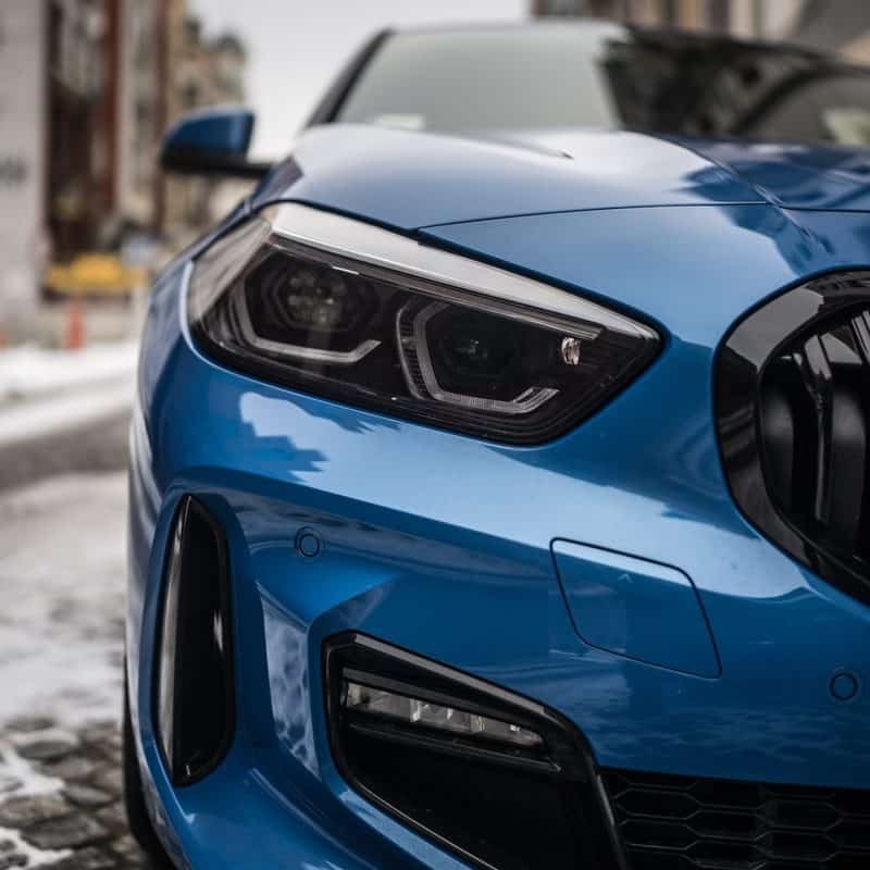 a blue BMW with sporty headlights